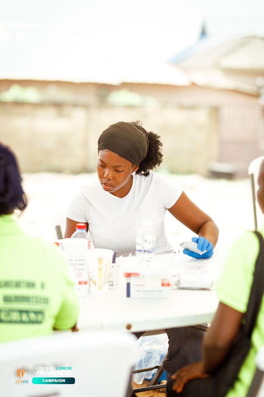 Health worker preparing materials at an awareness campaign